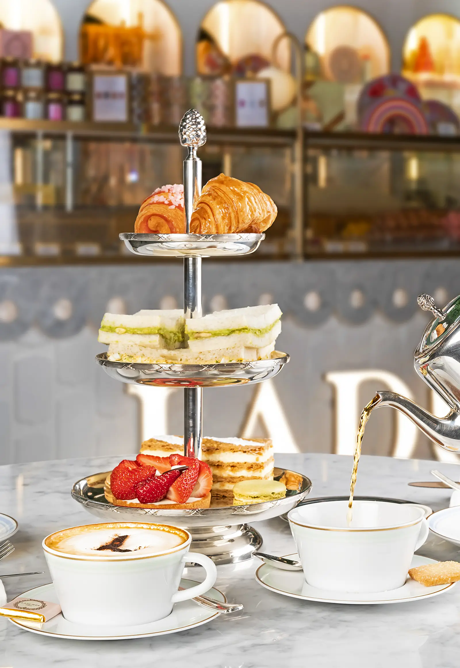 Afternoon tea set with pastries and macarons Ladurée