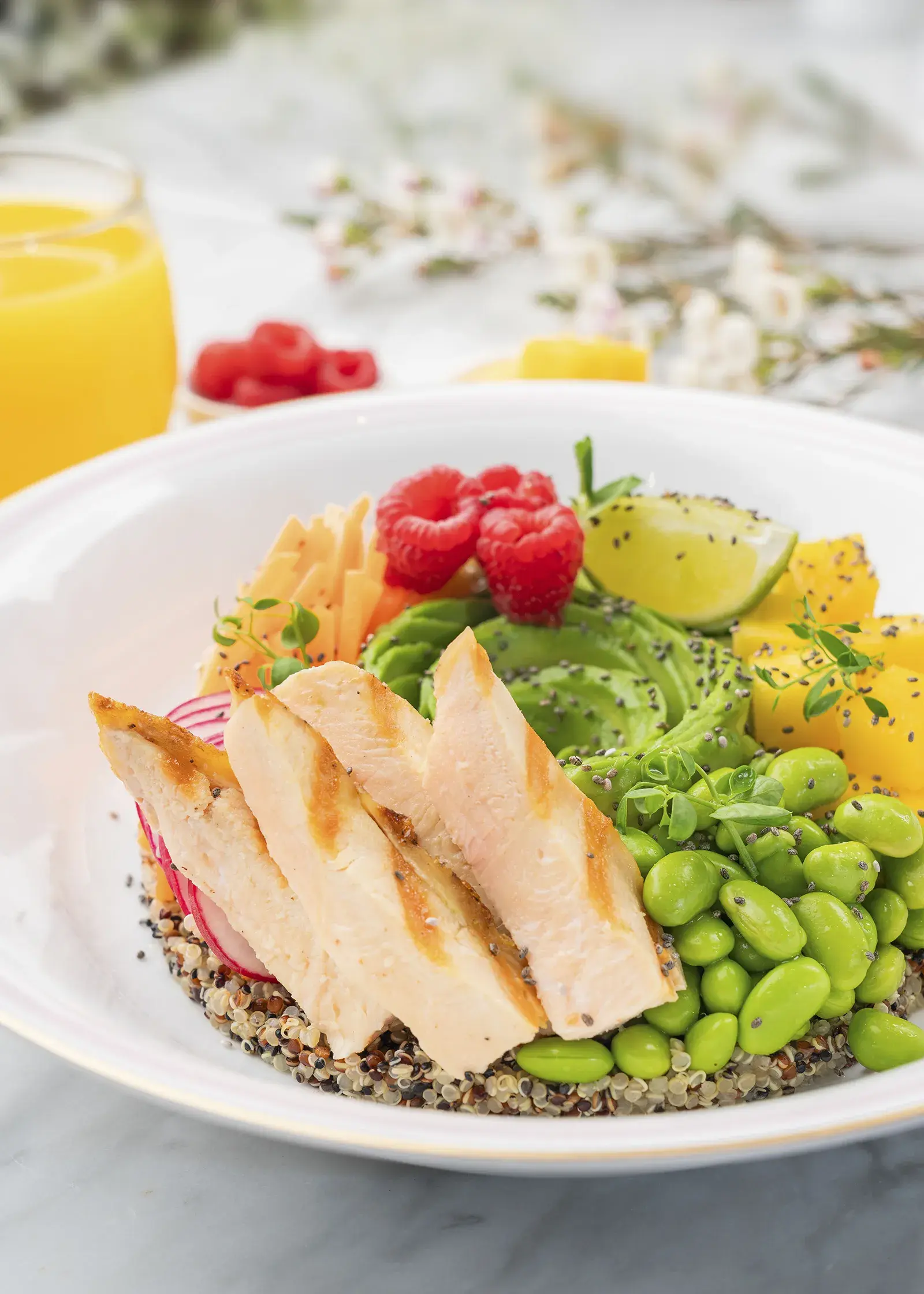 Chicken poke bowl with rice, avocado, and vegetables