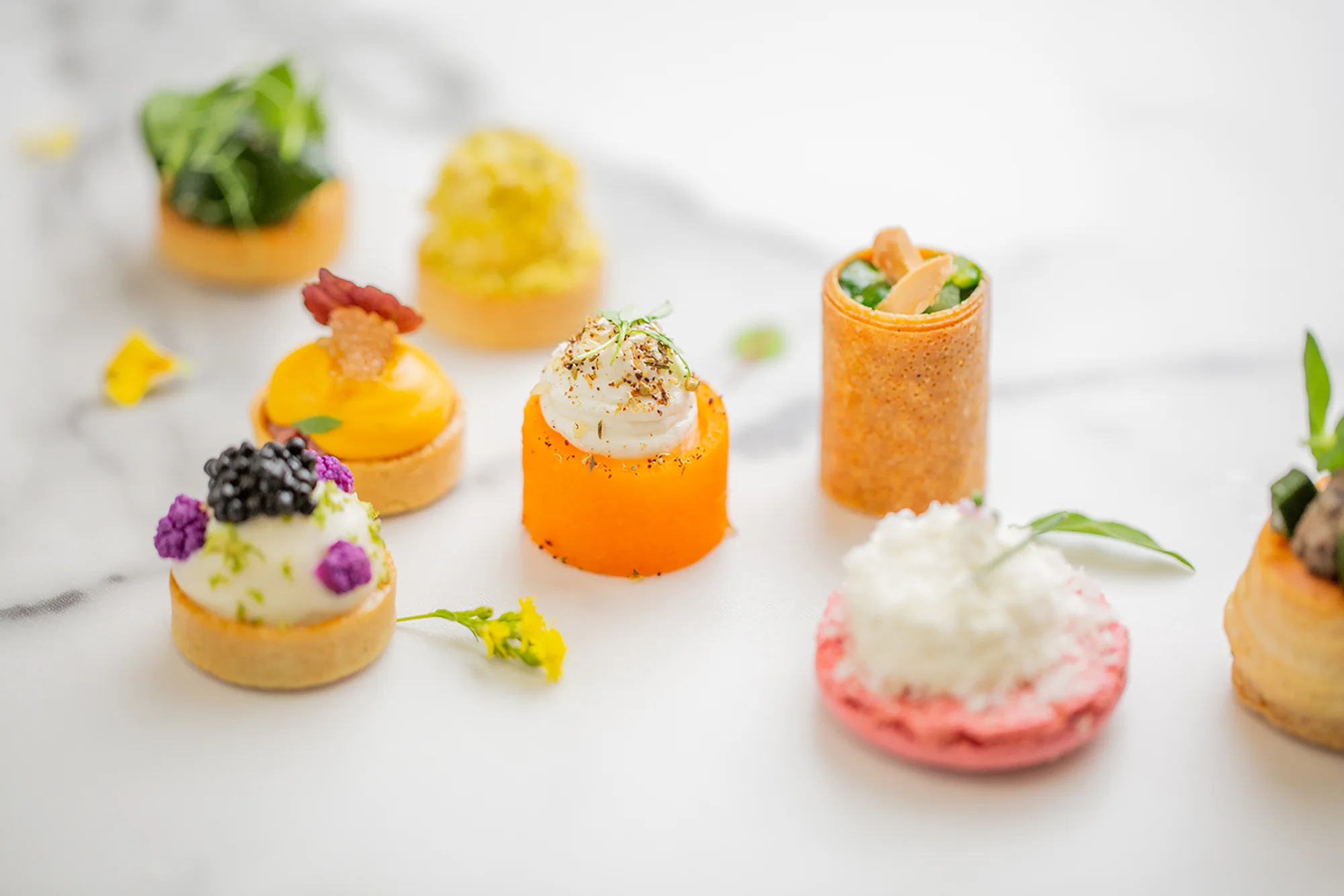 Elegant French catering setup by Ladurée with gourmet pastries and savory selections 3